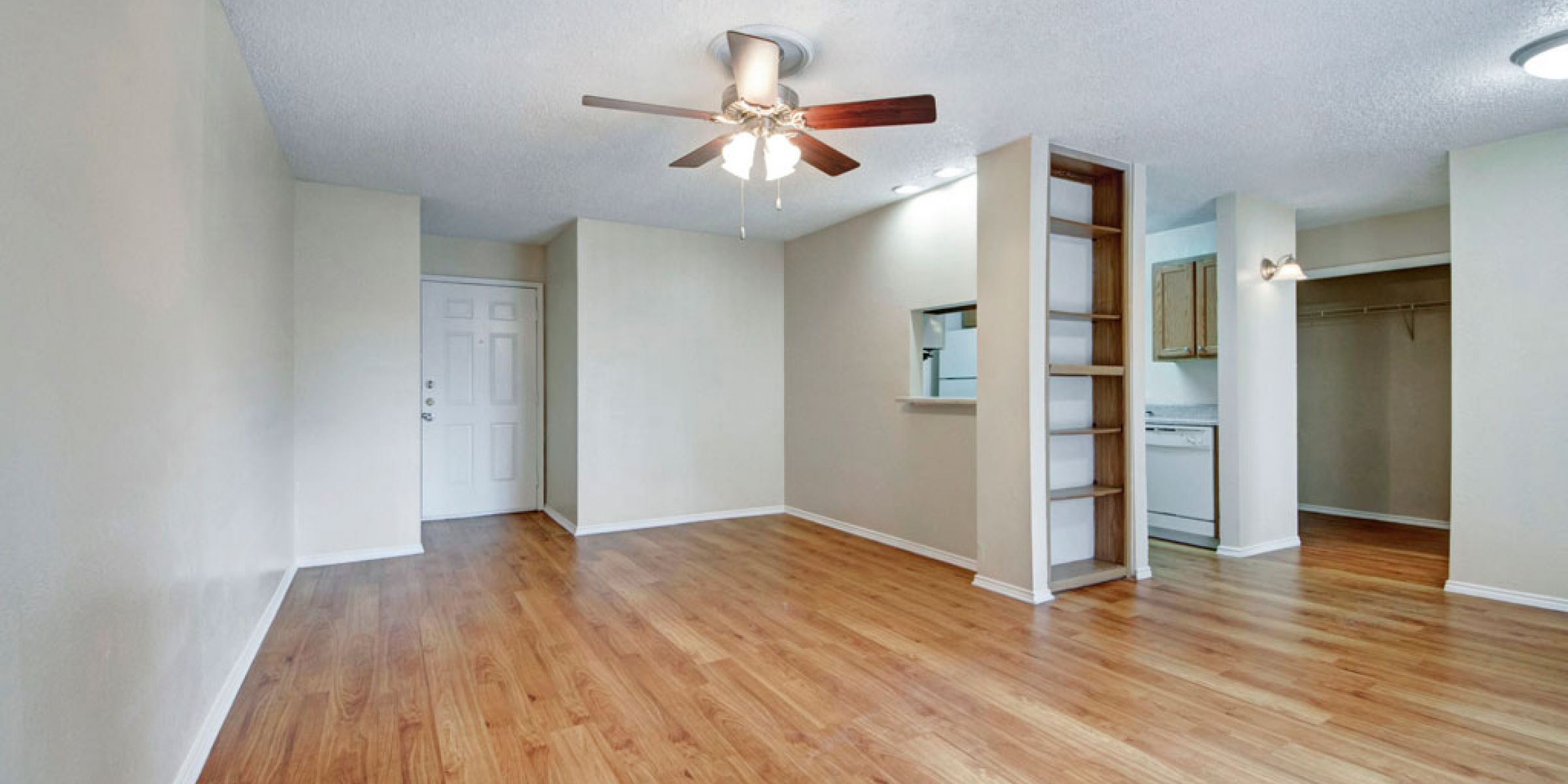 Luxury apartment living room with large windows, wood style floors and contemporary furniture at The Civic at Frisco Square